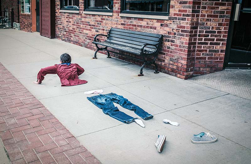 a segmented body crawling along a sidewalk